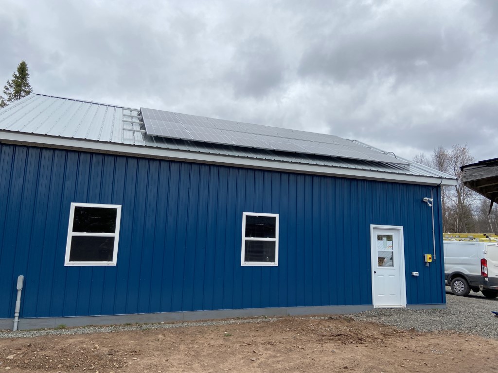 Solar array on a metal roof viewed from the ground