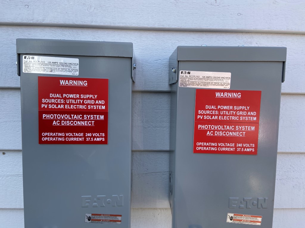 Photovoltaic system AC disconnects with dual power supply warning labels